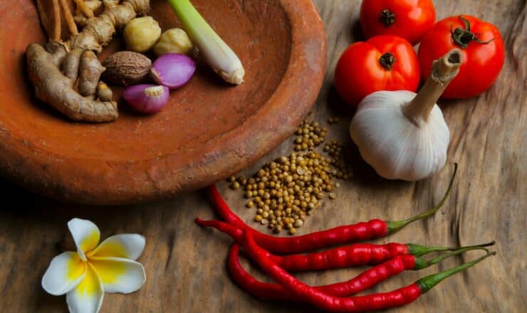 round brown clay bowl with vegetables