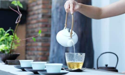 person holding kettle