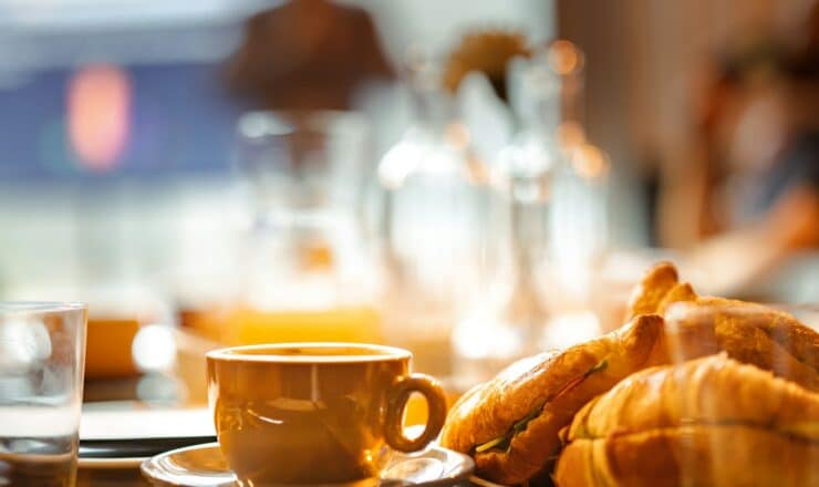 a plate of croissants and a cup of coffee