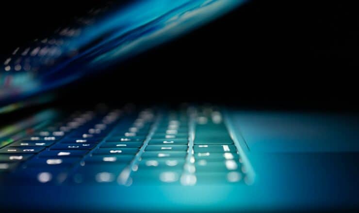 closeup photo of turned-on blue and white laptop computer