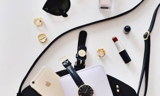 women's sunglasses and black bag with watch and iPhone 6