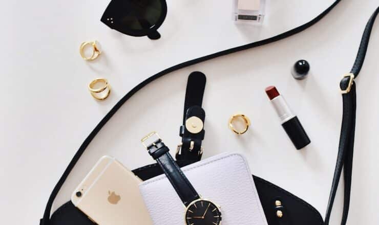 women's sunglasses and black bag with watch and iPhone 6