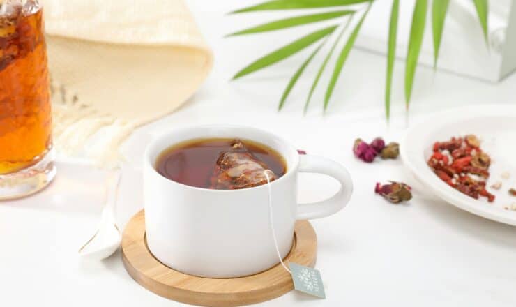 white ceramic mug with brown liquid inside
