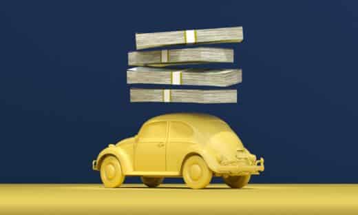 a yellow car with stacks of money on top of it