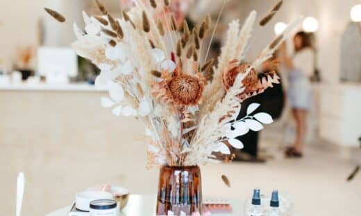 a white table topped with a vase filled with flowers