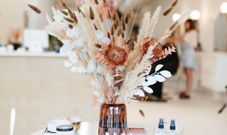 a white table topped with a vase filled with flowers