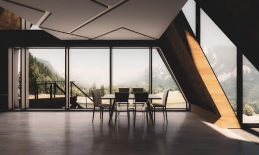 a room with a table chairs and a large window