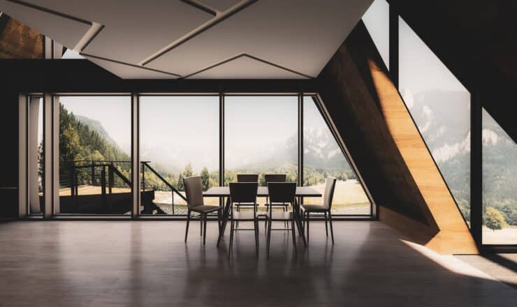 a room with a table chairs and a large window