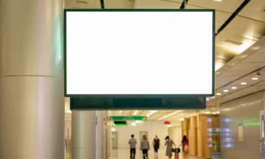 a large white sign hanging from the side of a building