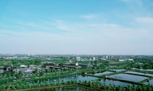 an aerial view of a city with a lake in the foreground