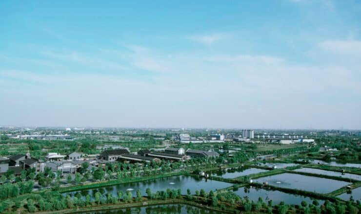 an aerial view of a city with a lake in the foreground