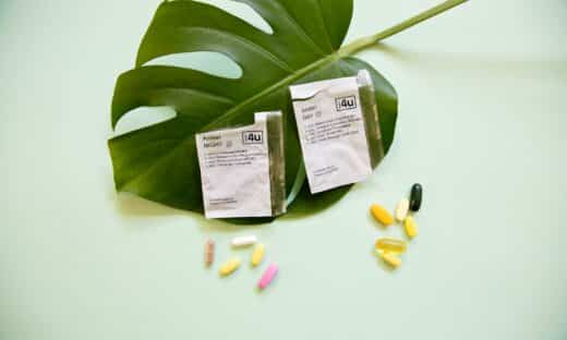 white and yellow medication pill on green leaf