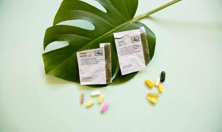 white and yellow medication pill on green leaf